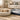 Golden retriever puppy sleeping on a round plush pet bed beside a grey waterproof rectangular dog bed in a bright living room