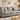Gray stretch spandex sofa slipcover fitted on a three-seater couch in a bright living room