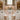 Wedding banquet tables with floor-length white tablecloths and a fitted spandex buffet table cover